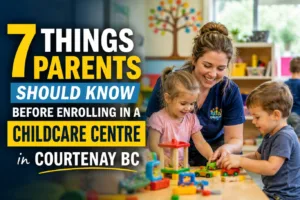 Childcare centre in Courtenay BC with a caring educator supervising young children playing with educational toys in a safe, engaging, and nurturing early learning environment