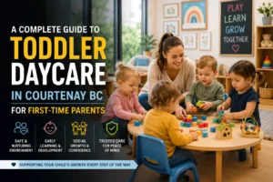 Toddler daycare in Courtenay BC with a caring childcare educator supervising toddlers during interactive play and early learning activities in a safe, nurturing daycare classroom designed for child development and social growth